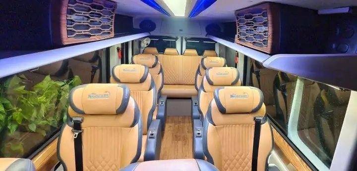 Luxury van interior with tan leather seats and blue ambient lighting