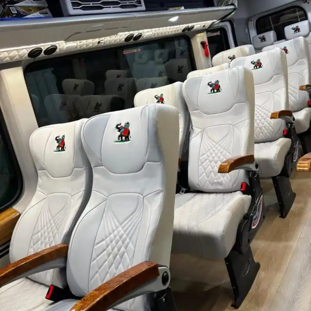 Reclining white leather seats with an embossed elephant emblem