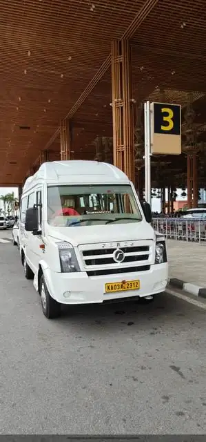 White Tempo Traveller 12 seater parked at the airport