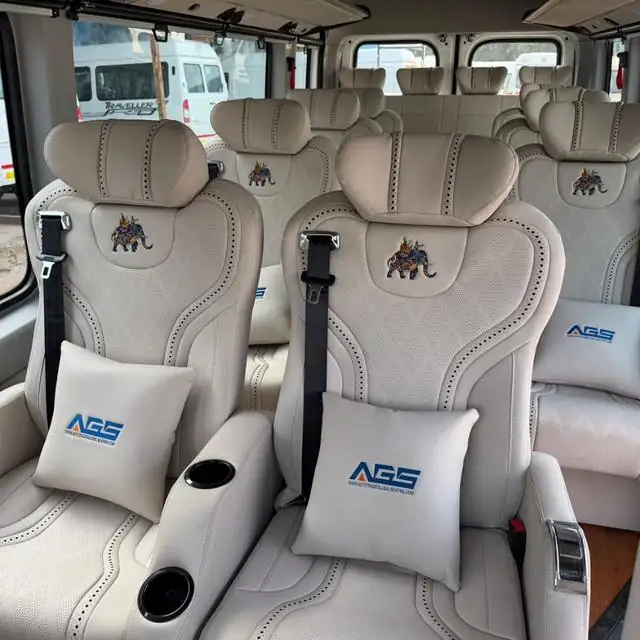 White leather seats with cushions and cup holders inside a van