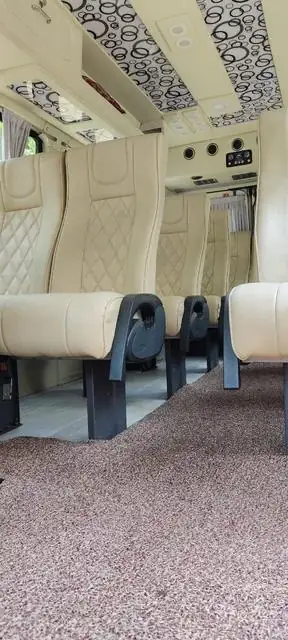 Maharaja Tempo Traveller cream sofa-style seats