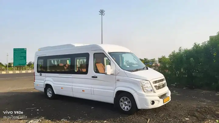 White Urbania 12 seater Maharaja, side view